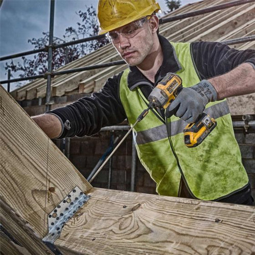 DeWalt DCF887N 18V Brushless Impact Driver in use on site.